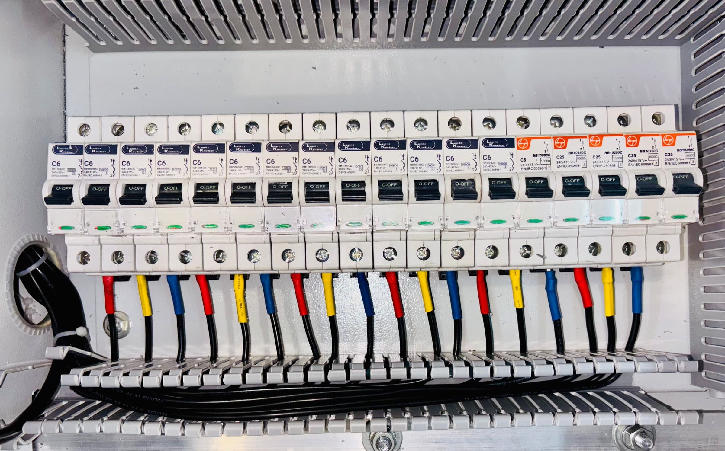 Rows of circuit breakers in a three phase distribution board